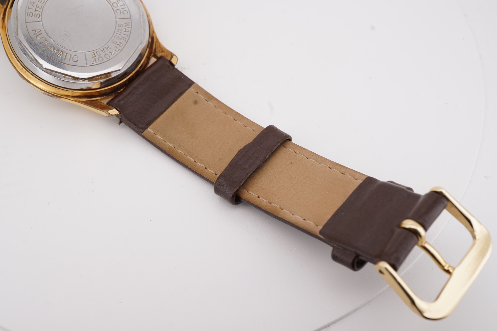 A gentleman's steel and gold plated Montfort Superautomatic wrist watch, with Roman and quarterly Arabic numerals, case diameter 34mm, on a later associated leather strap.
